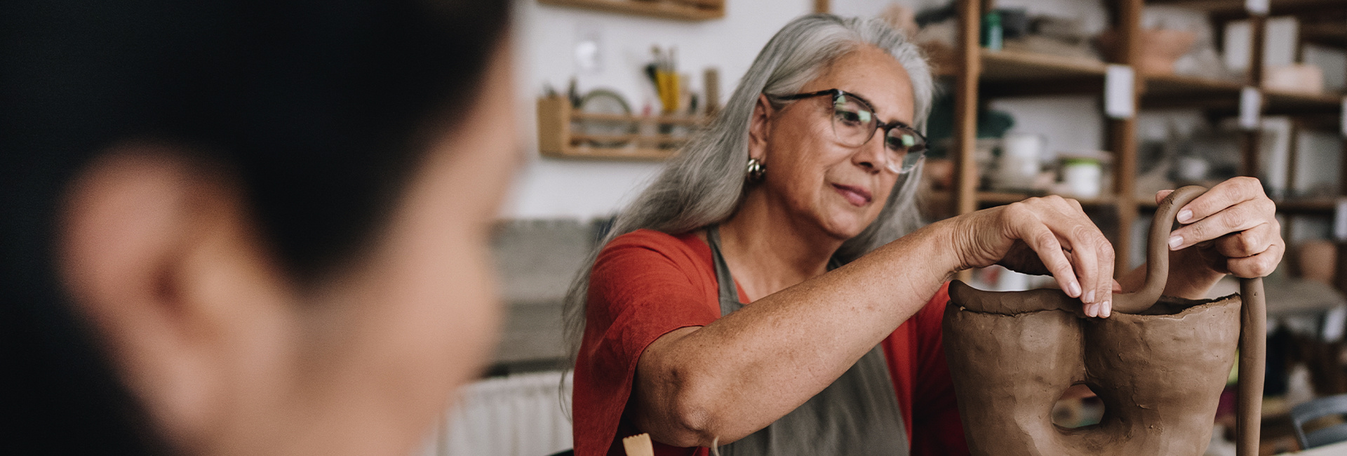 Senior woman enjoying a pottery class. 