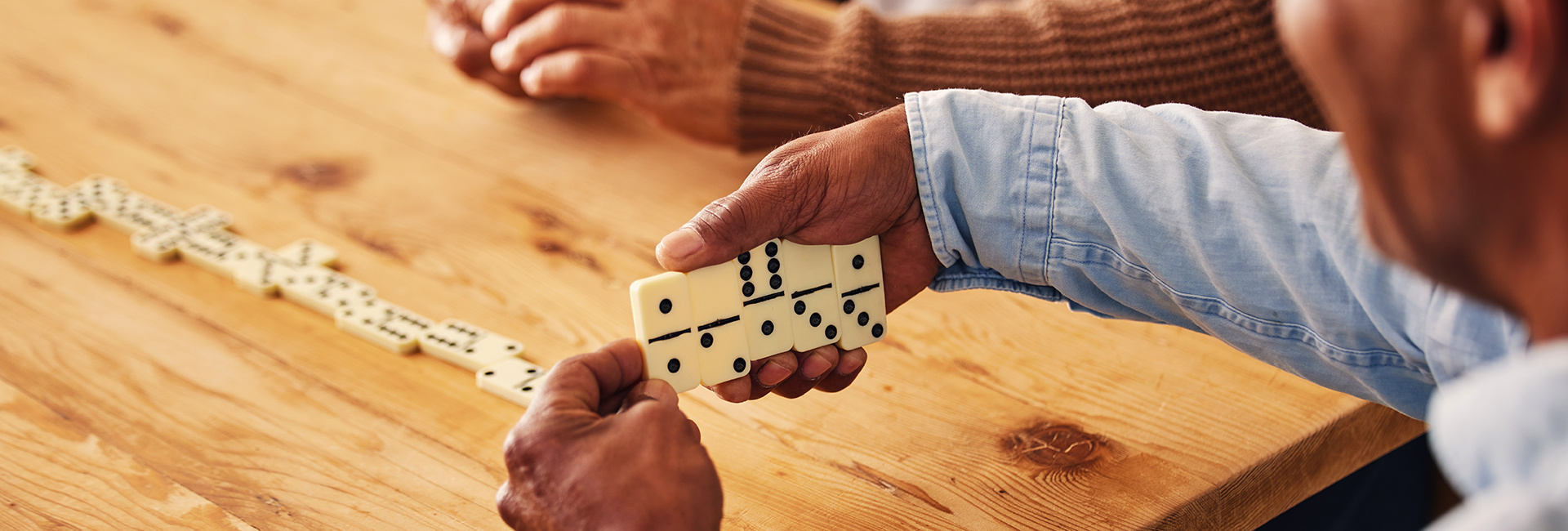 Friends playing dominos together. 