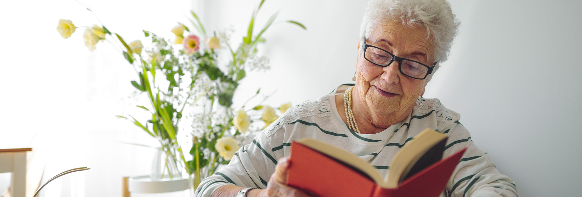 Older woman reading a book. 