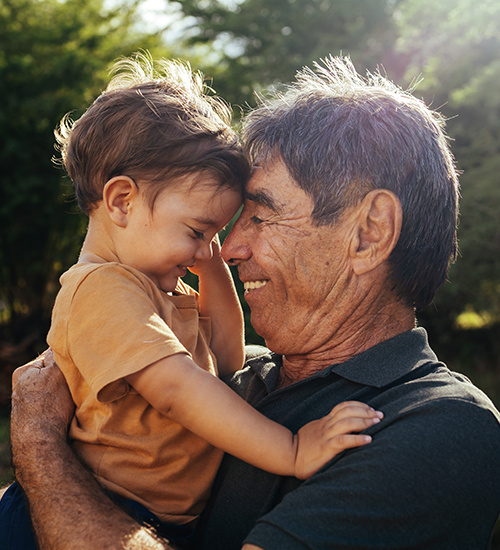 Grandpa holding his grandson. 