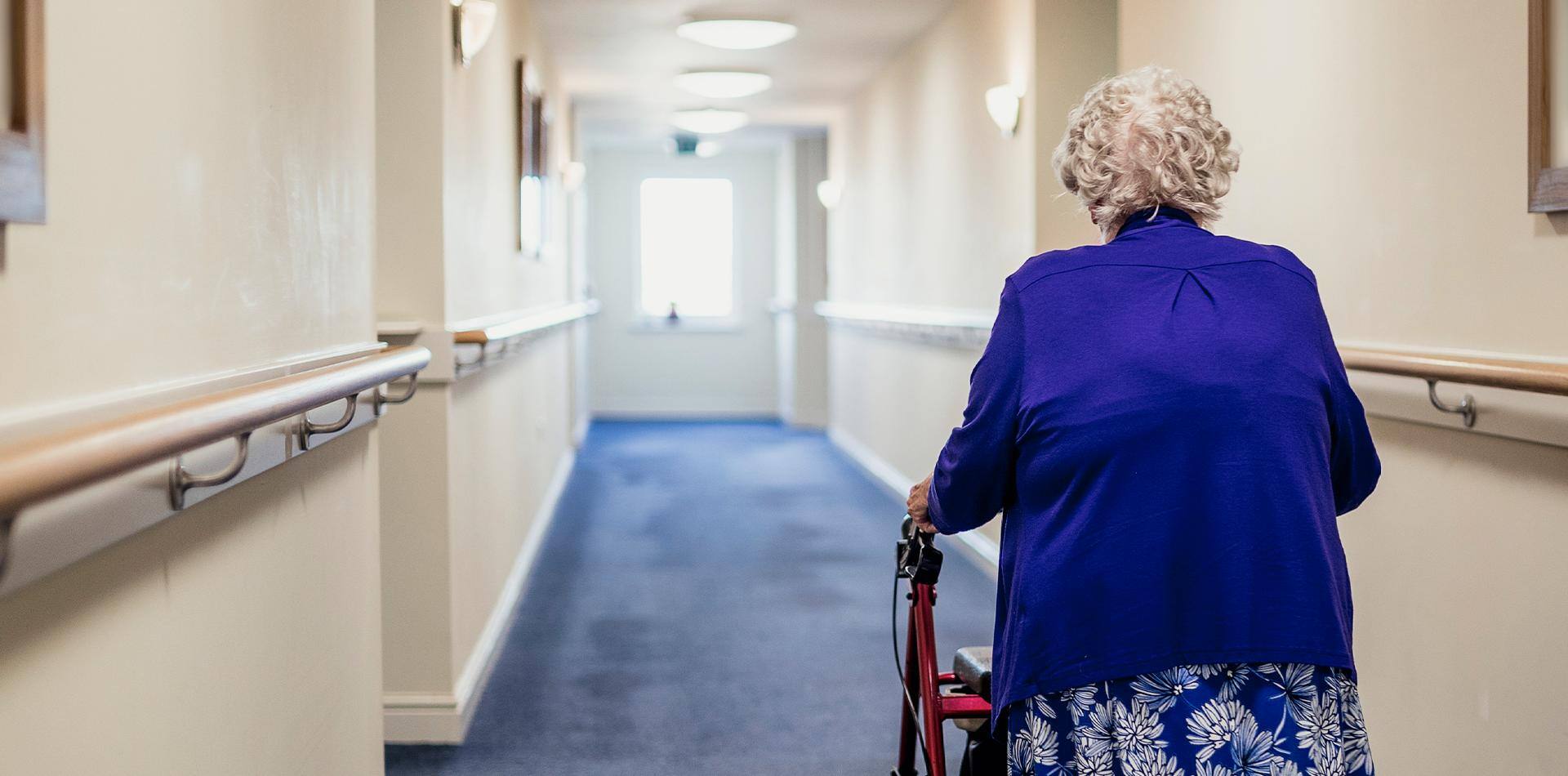 Older woman using a walker goes to lunch. 