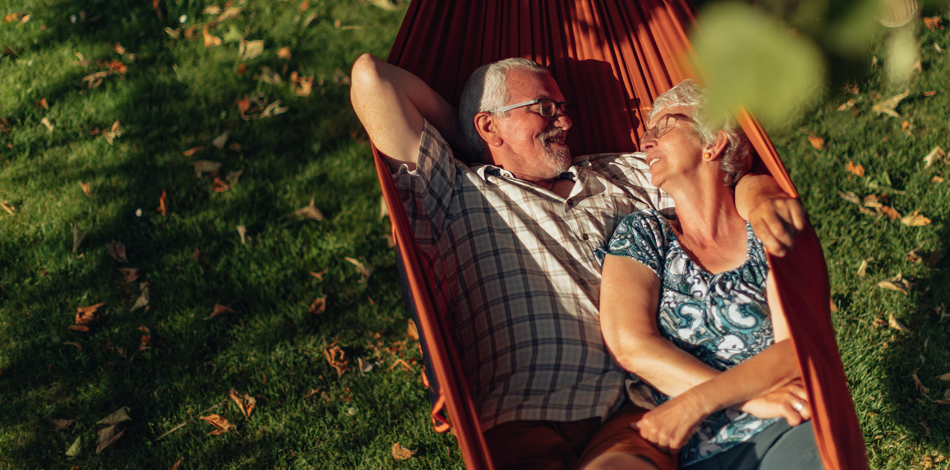 Older couple enjoying an afternoon in a hammock. 