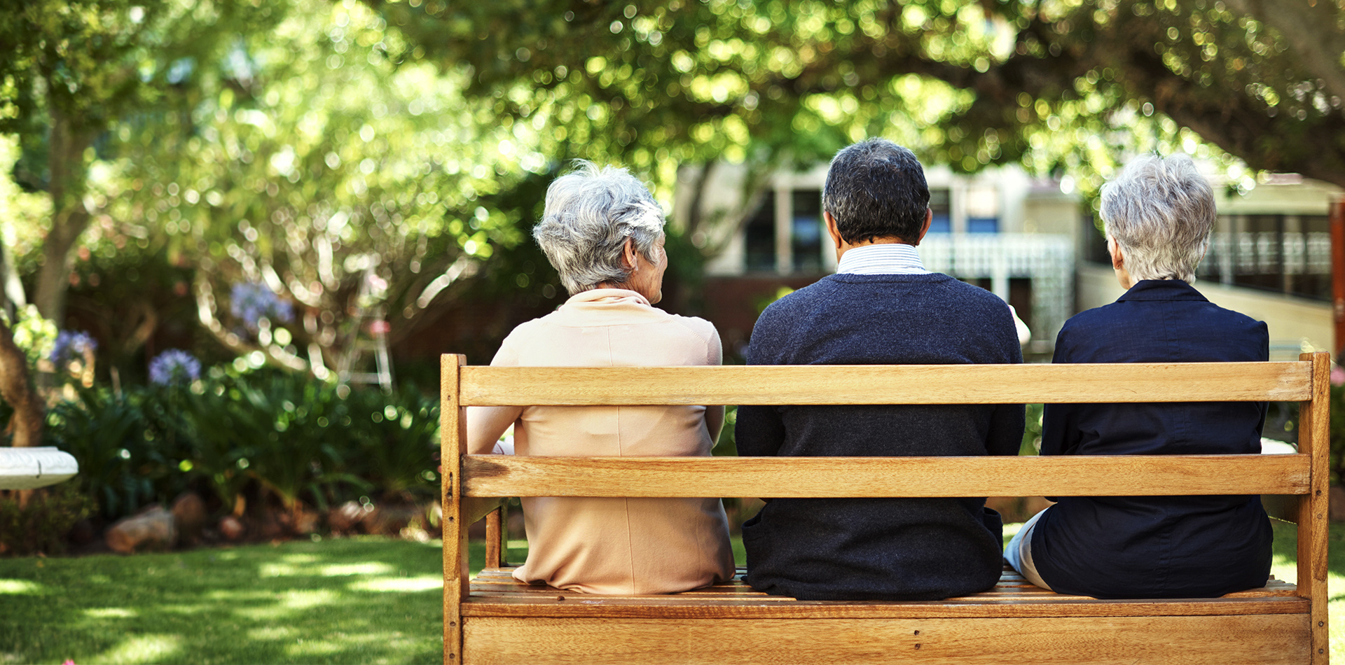Three friends sitting on a bench together. 