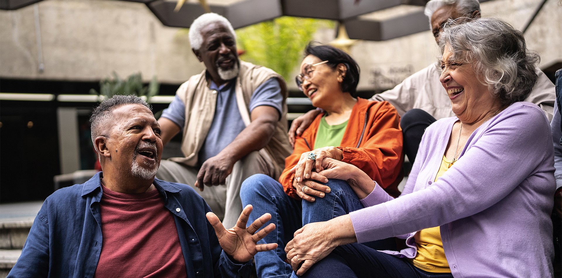 Old friends enjoy a conversation outside. 