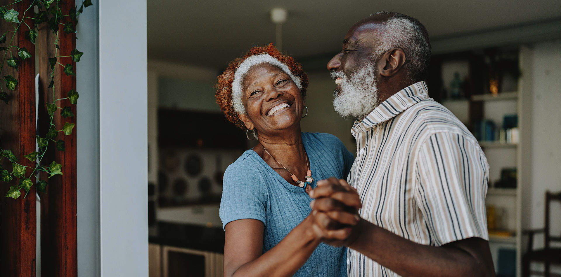 Older couple enjoying a dance in the living room.