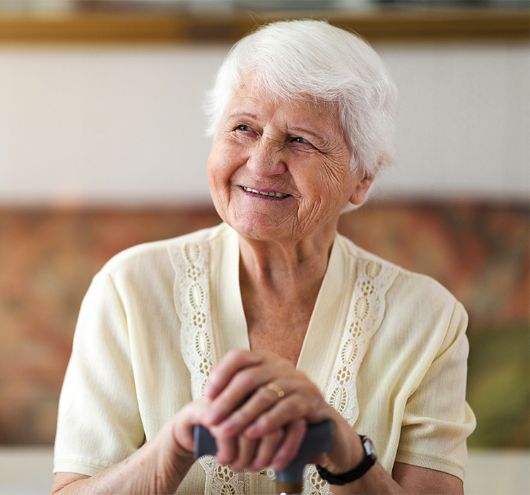 Memory care resident smiles at you. 