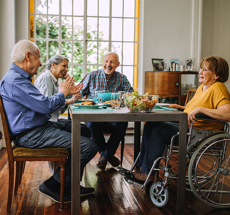 Friends enjoy a meal together at the table. 