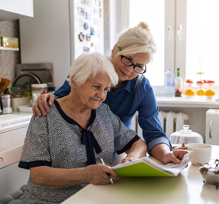 Mother and daughter looking over a care plan together. 