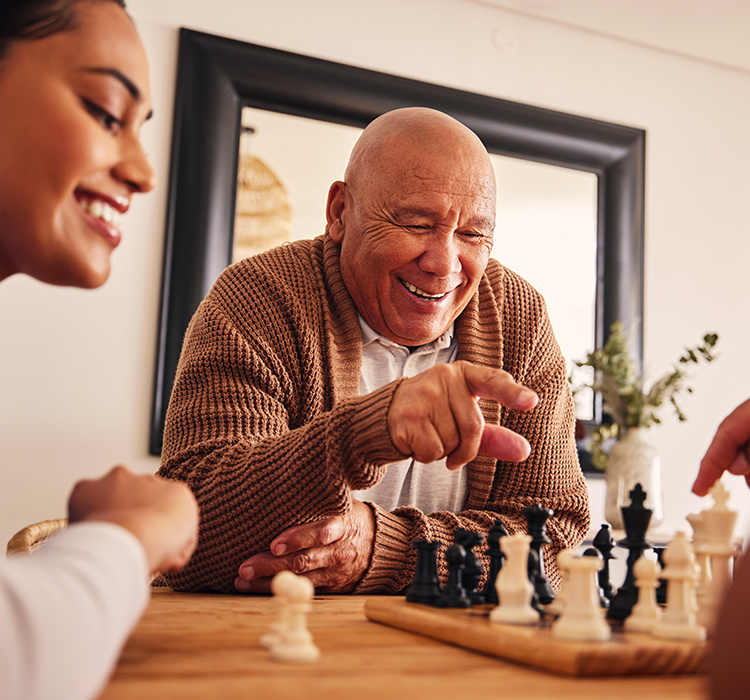 Father and daughter play a game of chess. 