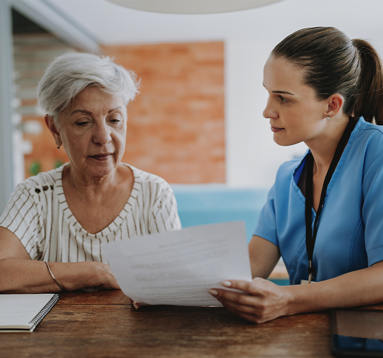 Nurse helping a resident understand her care plan. 