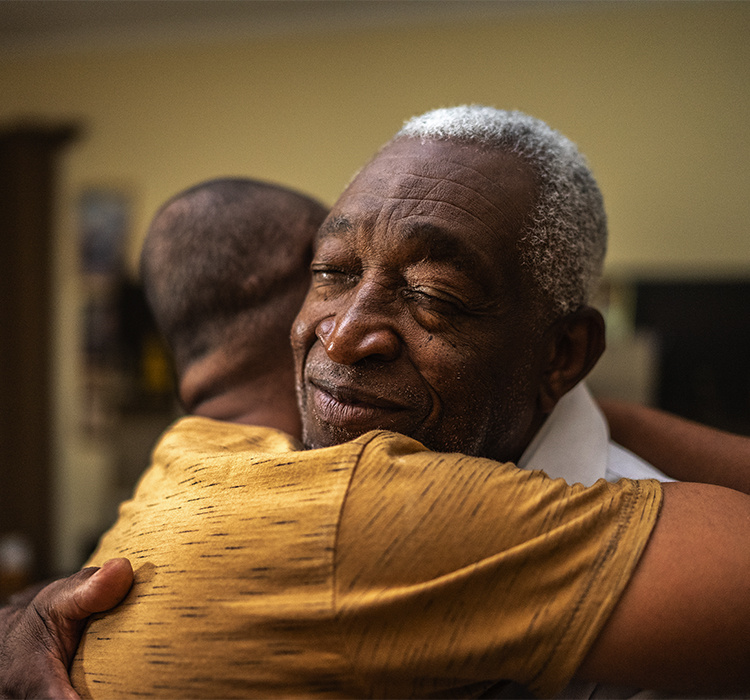 Father and son embrace. 