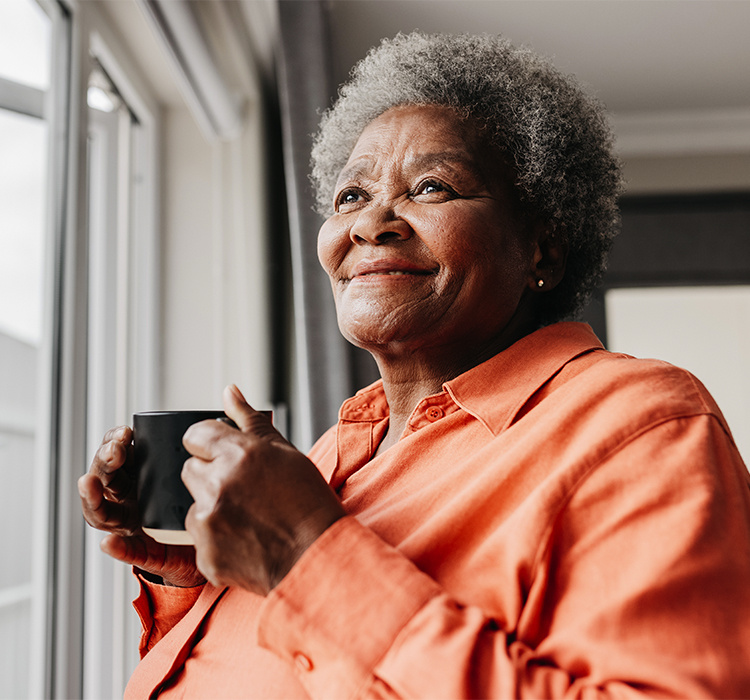 Older woman enjoying a cup of coffee. 