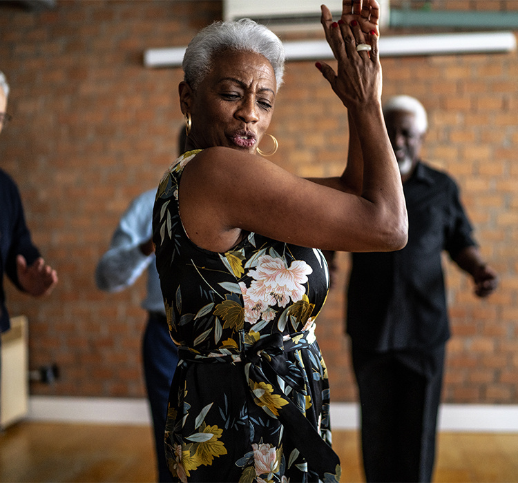 A woman enjoys a dance class. 
