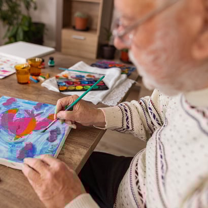 man painting creative engagement provides residents with consistent opportunities to experience joy and value through art, music, and other creative outlets