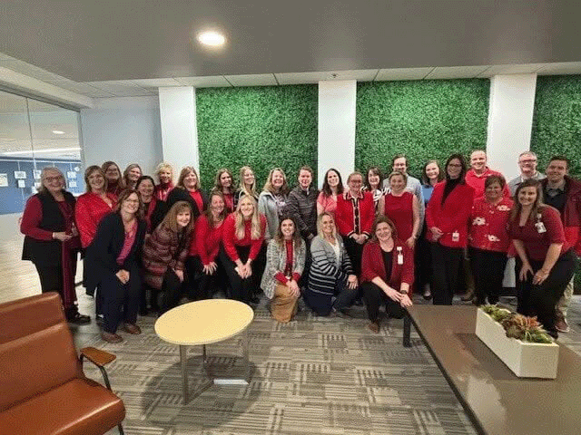 group of ebenezer employees all wearing red shirts