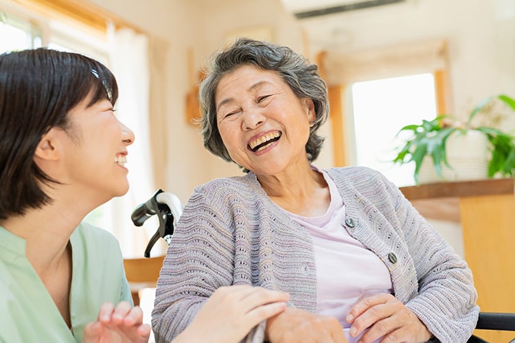 two senior women laughing